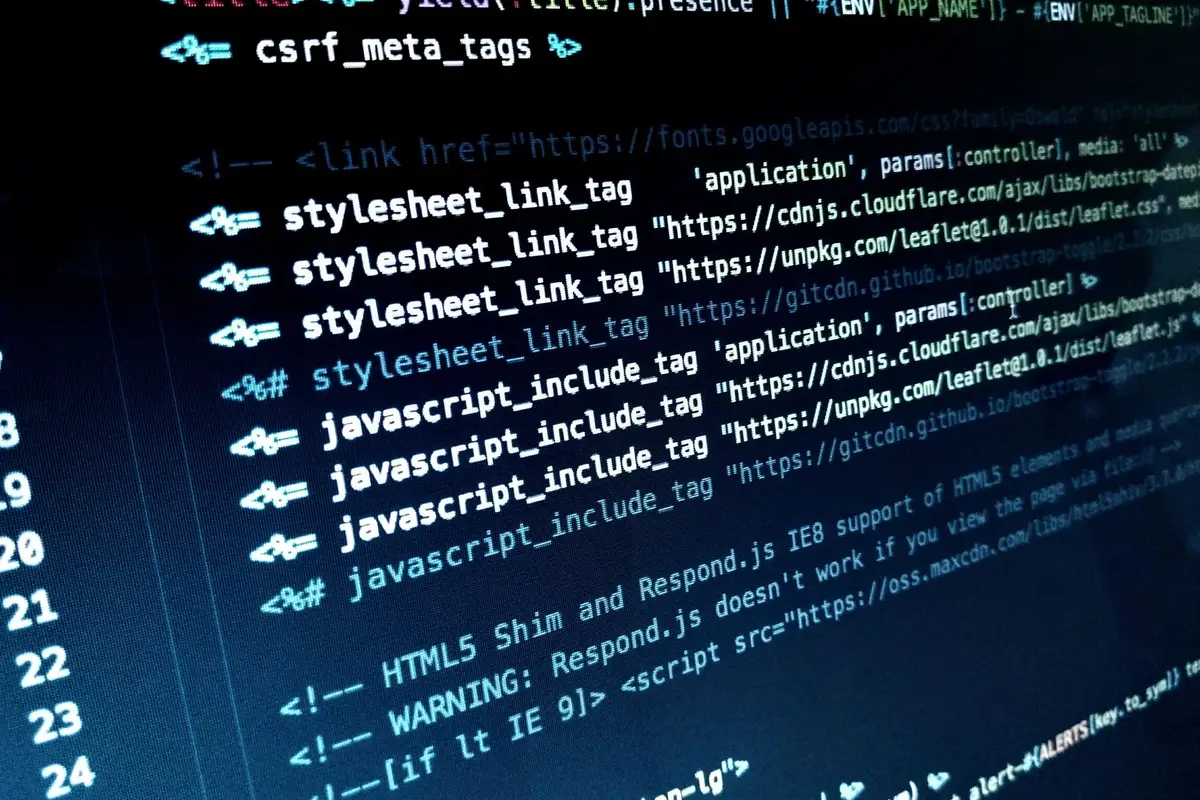 Lines of web page code on a monitor, including the tags that load the page’s JavaScript files